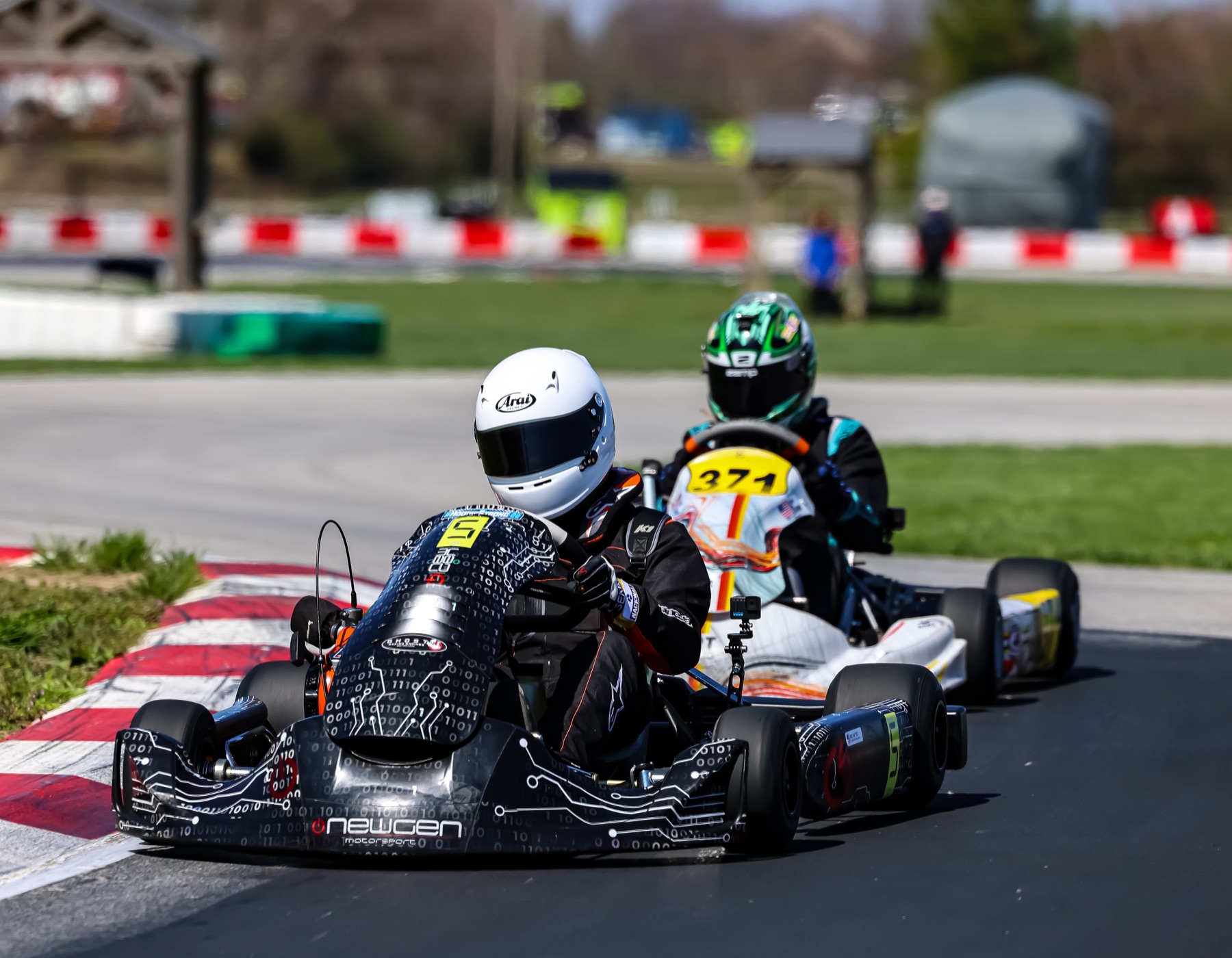 Emmett King leading another junior kart through the turn