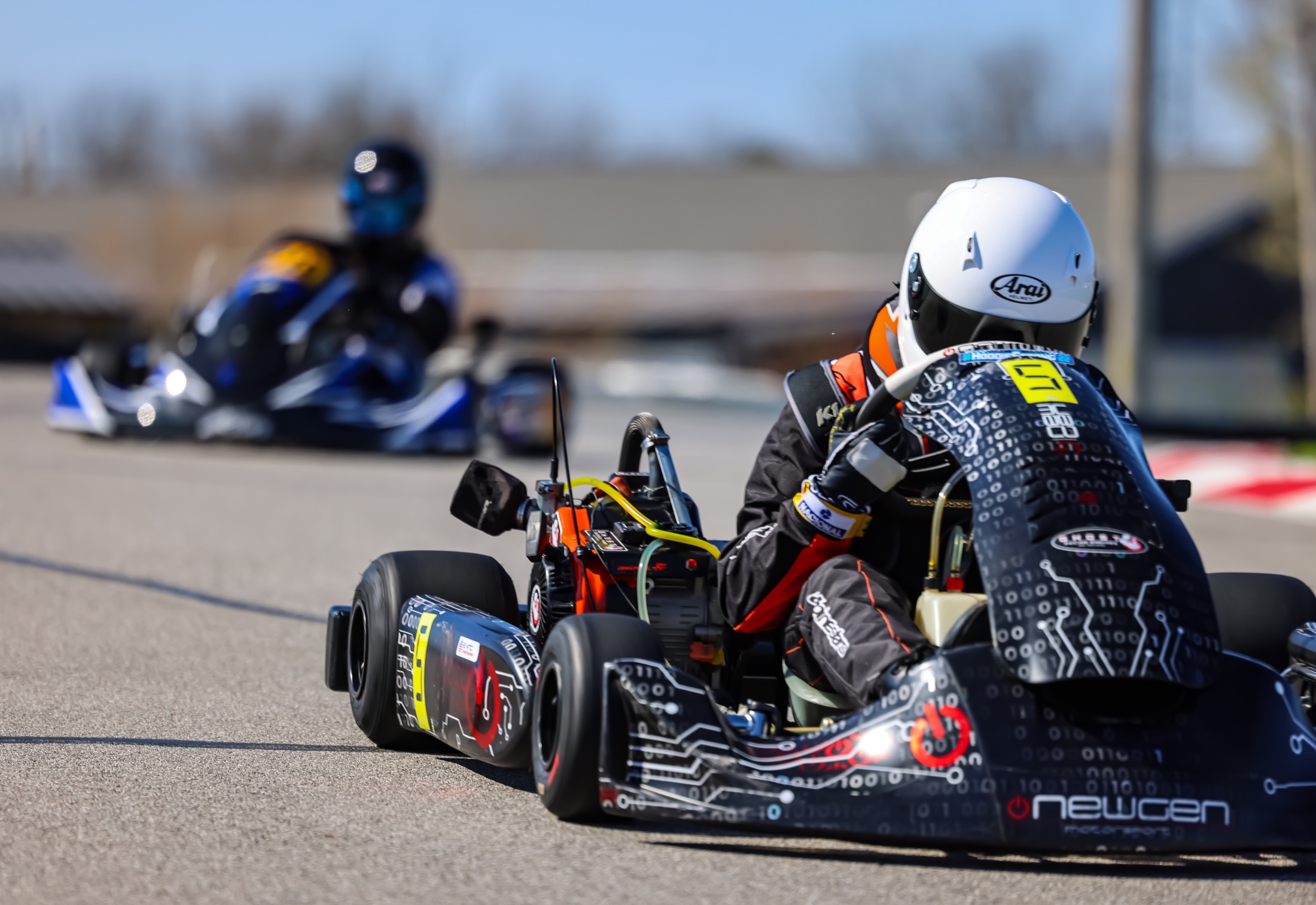 Close rear view of the number 5 kart chasing another racer